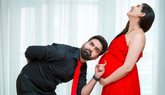 Mother holding newborn during a maternity shoot